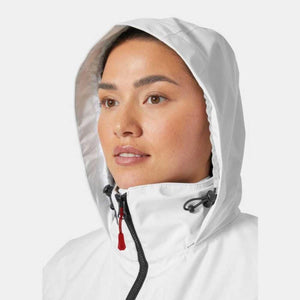 Woman wearing a white hooded jacket with a black zipper and red pull tab