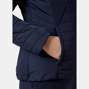 Close up of a navy blue Helly Hansen quilted jacket pocket with hand inside