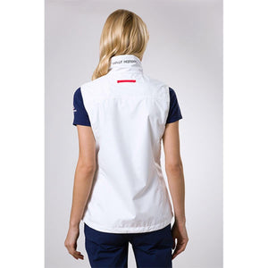 Back view of a woman wearing a white Helly Hansen vest over a navy blue shirt