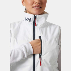 Person wearing a white Helly Hansen vest with a zippered chest pocket