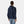 Back view of a person wearing a navy blue Helly Hansen hooded jacket with white trim at the hem