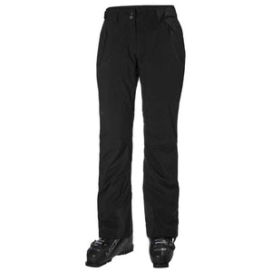 Helly Hansen black ski pants with zippered pockets and ski boots