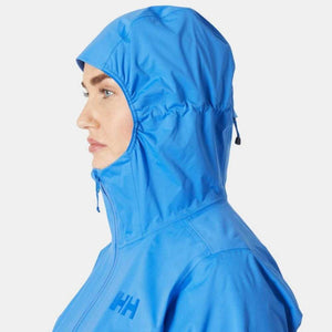 Side profile of a person wearing a bright blue Helly Hansen hooded rain jacket