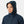 Person wearing a navy Helly Hansen hooded rain jacket