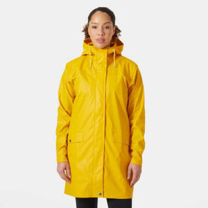 Woman wearing a yellow Helly Hansen hooded raincoat