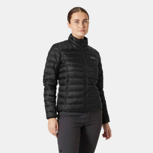 Woman wearing a black Helly Hansen quilted down jacket with a high collar and HH logo