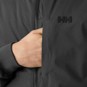 Hand in the pocket of a black Helly Hansen jacket featuring the HH logo