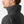 Profile view of a man wearing a black Helly Hansen jacket with a high collar
