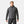 Man wearing a dark grey Helly Hansen hooded hybrid jacket with quilted front and knit sleeves