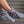 Person wearing grey plush ankle slippers