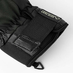 Black winter glove cuff with Gore-Tex label and adjustable velcro strap