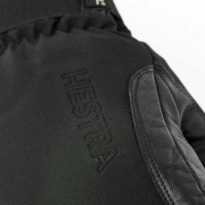 Black Hestra glove with embossed logo and leather detailing