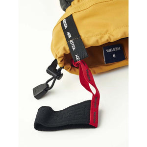 Hestra yellow glove cuff with black drawstring and red wrist strap