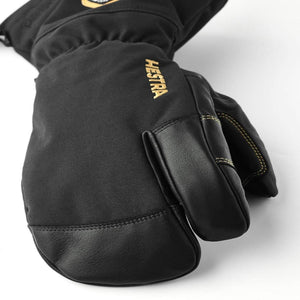 Black Hestra three finger ski glove with leather palm and gold logo