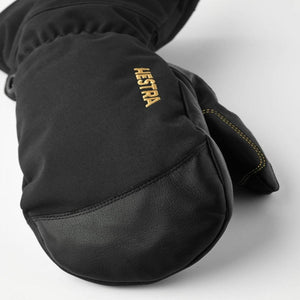 Black Hestra mitten with leather palm and gold logo embroidery