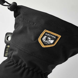 Black Hestra glove cuff with Gore-Tex branding and Hestra logo patch