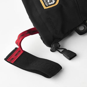Hestra black glove cuff with red pull tab and Gore-Tex logo
