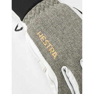 Close up of Hestra glove with grey textured fabric and white leather detailing