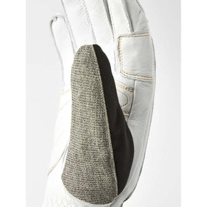 Hestra white leather glove with a textured black nose wipe patch on the thumb