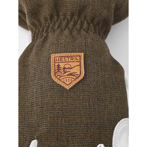 Hestra olive green textured glove with a leather brand logo patch