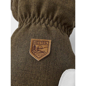 Olive green Hestra glove with leather brand logo patch