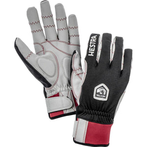Hestra black and grey gloves with red accents and velcro wrist straps