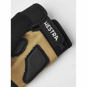 Close up of Hestra glove cuff with velcro strap and tan suede palm with black leather padding