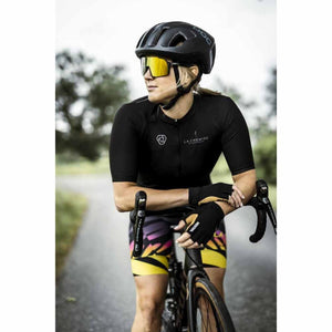 Cyclist wearing Hestra fingerless gloves and POC helmet leaning on handlebars