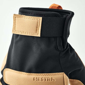 Hestra glove cuff with tan leather velcro strap and black fabric