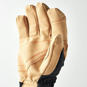 Tan work glove with orange stitching and black fabric side panel