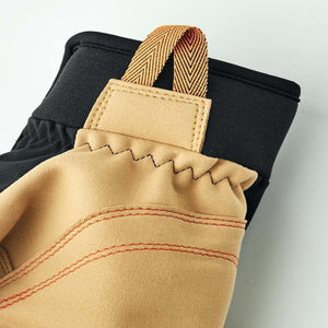 Close up of Hestra glove cuff with tan leather pull tab and black fabric