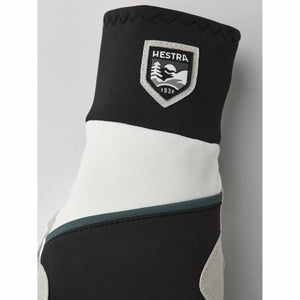 Hestra glove cuff with black and white panels and brand logo patch