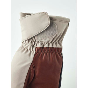 Hestra glove cuff with beige fabric and brown leather detail featuring a velcro closure