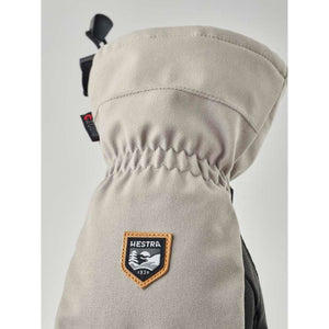 Hestra grey mitten with elastic wrist and brand logo patch