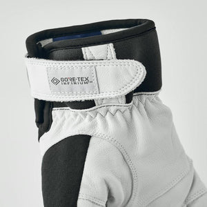 Close up of white and black leather glove cuff with Gore-Tex Infinium branding on velcro strap