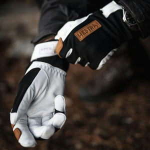 Hestra black and white leather gloves with brown logo patch