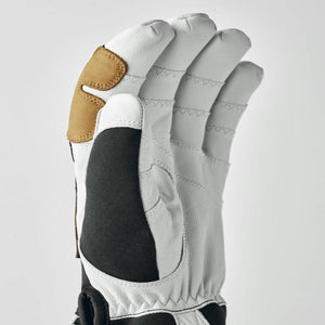 Hestra white leather glove with black fabric and tan leather detail on index finger