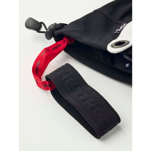 Hestra glove cuff with red pull tab and black wrist strap