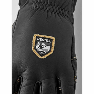 Black leather Hestra glove with brand logo patch