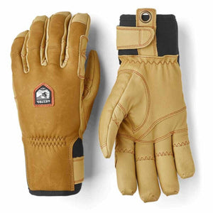 Hestra tan leather gloves with black cuffs and wrist adjustment straps