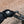 Person wearing black Hestra gloves while riding a bicycle on a paved path