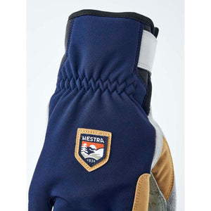 Hestra navy blue glove with elastic wrist and brand logo patch