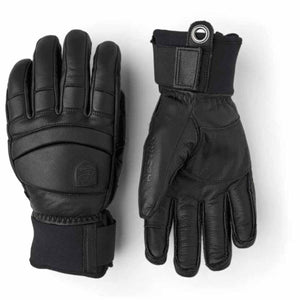 Pair of black Hestra leather ski gloves with adjustable wrist straps