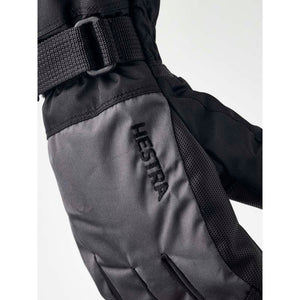 Close up of black Hestra ski glove with adjustable wrist strap