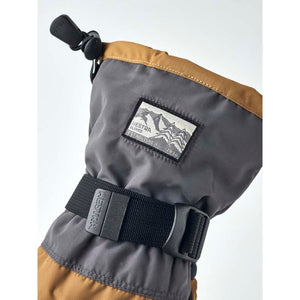 Hestra grey and brown winter glove cuff with adjustable strap and brand logo patch