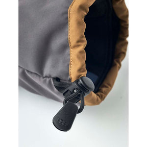 Hestra glove cuff with brown trim and black adjustable drawstring toggle