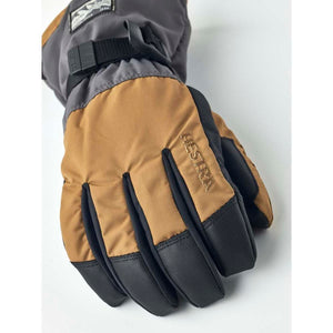 Hestra brown and grey winter glove with black textured fingertips and wrist strap