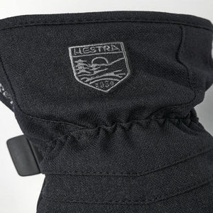 Black Hestra glove cuff with embroidered brand logo patch
