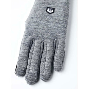 Grey Hestra knit glove with brand logo patch