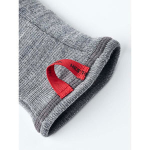 Grey Hestra glove cuff with a red pull tab